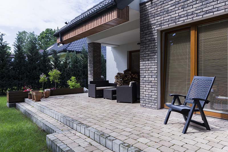 A residential landscaping project featuring a custom patio and paver installation.